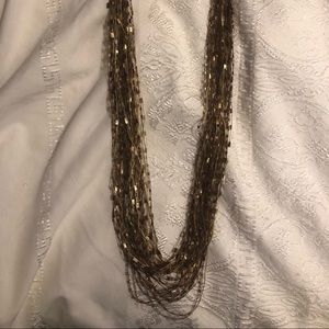 Gold toned 24” long material necklace